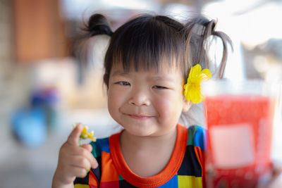 Portrait of smiling girl holding flower