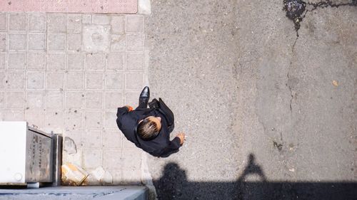 High angle view of man standing on footpath