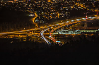 Light trails on bridge over city at night