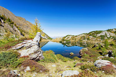 Scenic view of mountains against clear blue sky