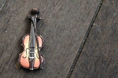 High angle view of figurine violin on table