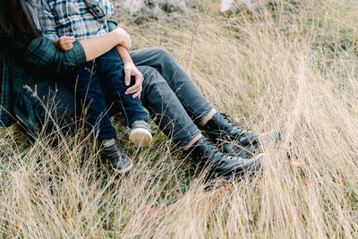 Low section of man sitting on grass