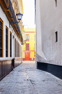 Empty alley amidst buildings in city