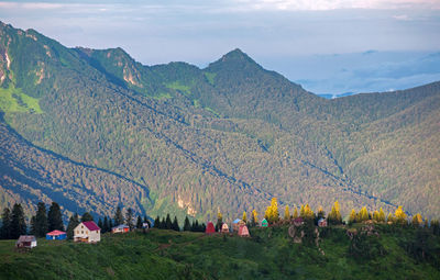 Panoramic view of people on mountain range against sky