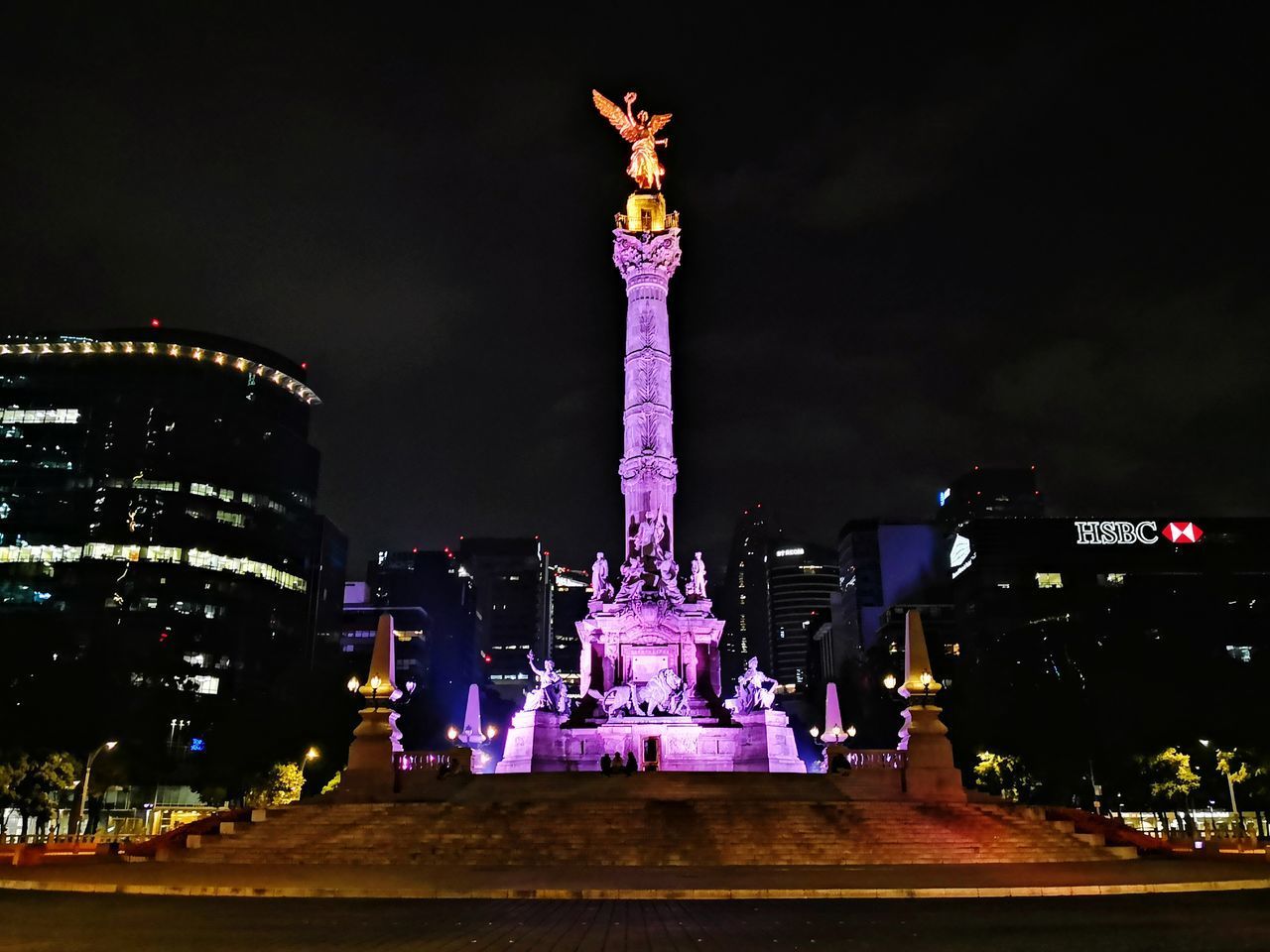 STATUE OF ILLUMINATED TOWER AT NIGHT