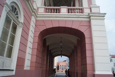 Low angle view of people walking on building