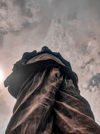 Low angle view of statue against cloudy sky