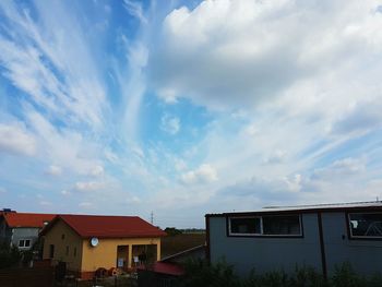 Houses against cloudy sky