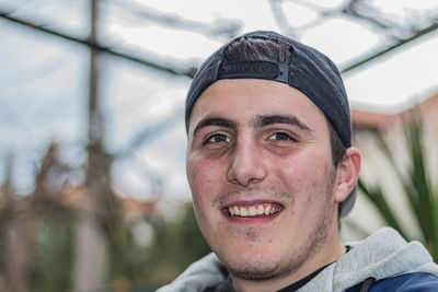 Portrait of young man smiling outdoors