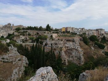 Panoramic view of buildings in city against sky