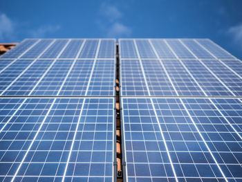 Low angle view of solar panels on roof against sky