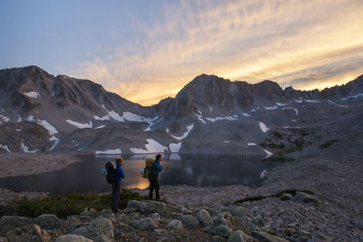 Women hikers watch sunset from pierre lakes, elk mountains, colorado