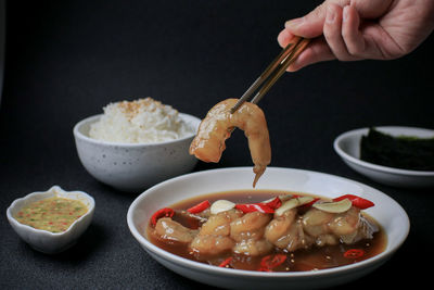 Cropped hand of person preparing food