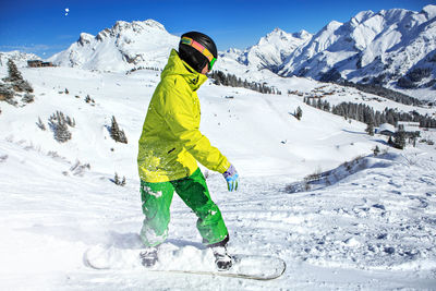 Young man skiing on snowcapped mountains during winter