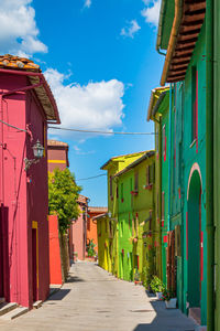 Street with different bright couloured walls in italy