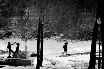 People walking on snow covered landscape