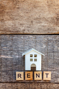 Close-up of text on wooden wall of building