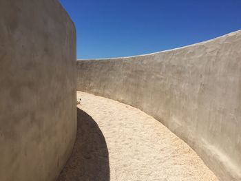 Low angle view of wall against blue sky