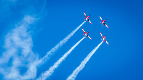 Low angle view of airshow against sky