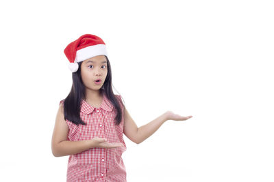 Portrait of happy girl standing against white background