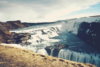 Scenic view of sea against cloudy sky