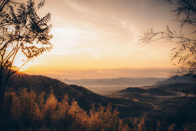 Scenic view of silhouette mountains against sky at sunset