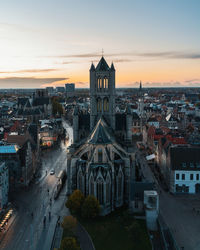 High angle view of buildings in city at sunset