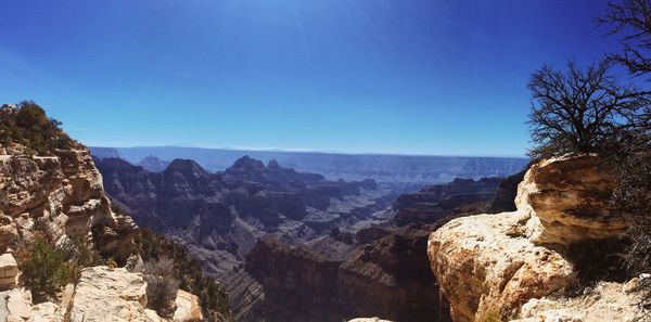 Scenic view of mountains against clear blue sky