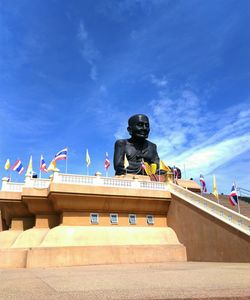 Low angle view of statue against blue sky