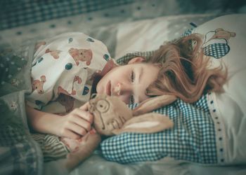 Midsection of woman lying down on bed