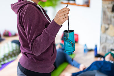 Midsection of man holding camera