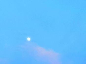 Low angle view of moon against blue sky