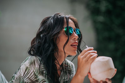 Portrait of a young woman drinking water