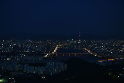 High angle view of buildings lit up at night