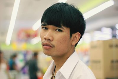 Close-up portrait of young man in supermarket