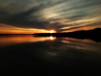 Scenic view of lake against romantic sky at sunset