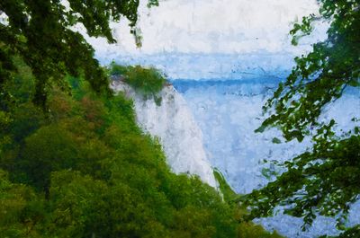 Scenic view of lake in forest against sky