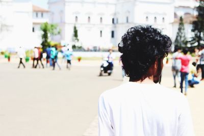 Rear view of people against blurred background