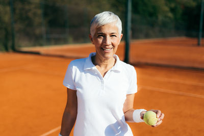 Beautiful mature woman at the tennis court