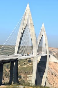 Low angle view of bridge against clear blue sky