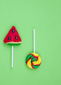 Close-up of multi colored candies on green background