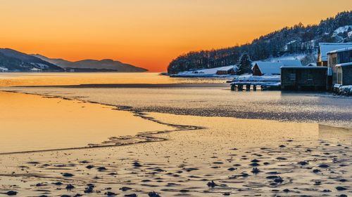 Scenic view of beach against sky during sunset