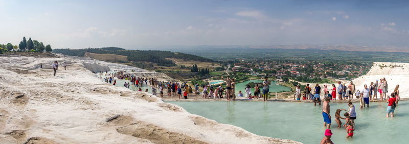 People at beach against sky