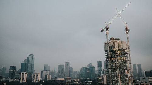 Modern buildings in city against sky