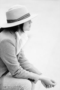 Side view of woman wearing hat