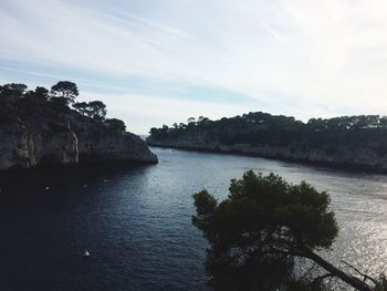 View of calm sea against mountain range