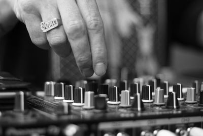 Cropped hand of person operating sound mixer