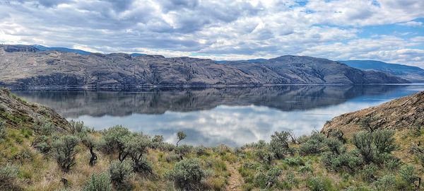 Scenic view of lake and mountains against sky