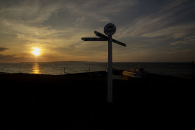 Scenic view of beach against sky during sunset