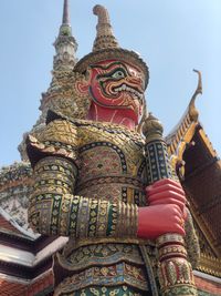 Low angle view of statue against temple